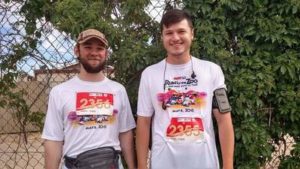 two guys standing and smiling before a run